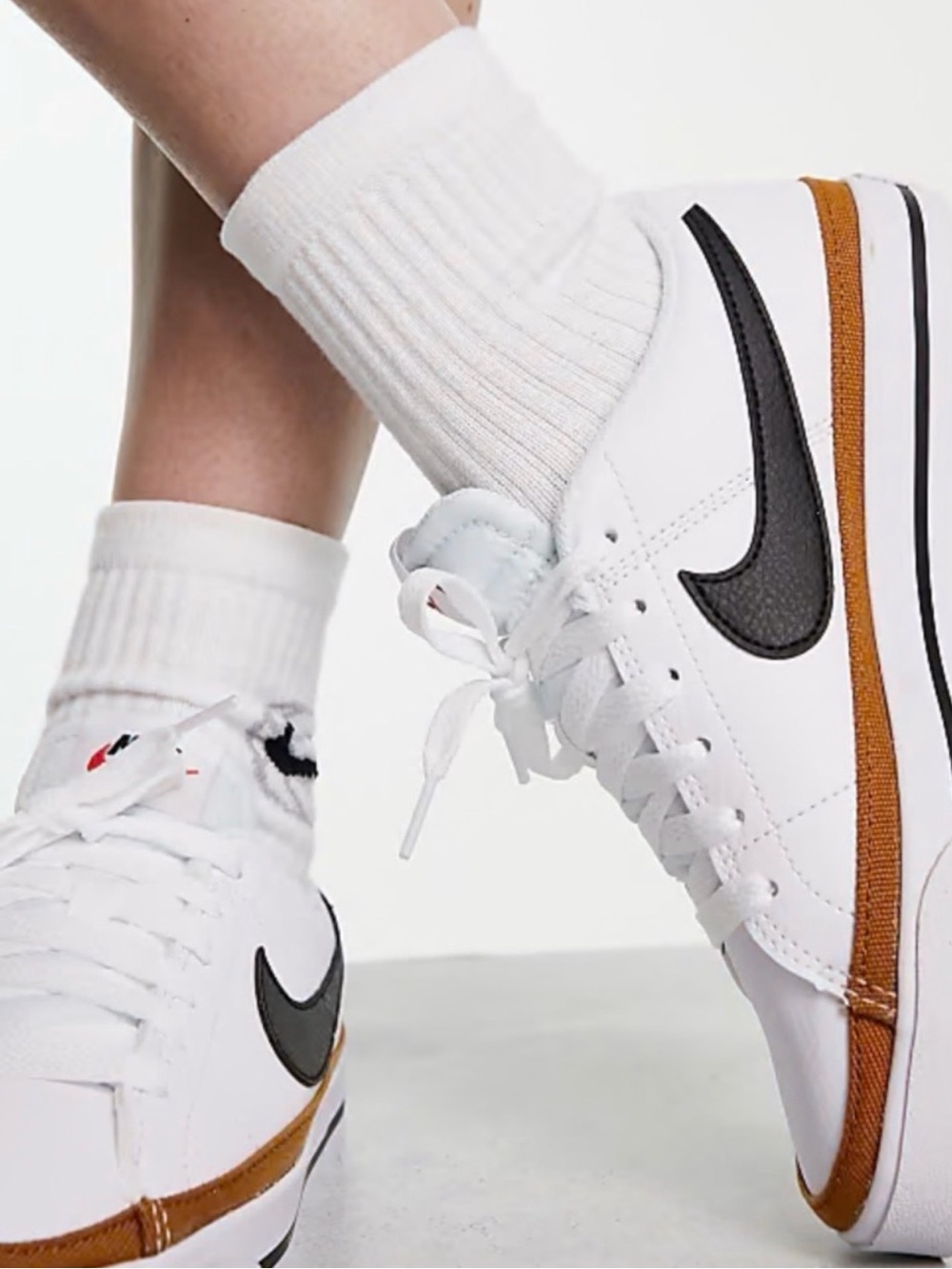 Nike Women’s White Sneakers with Black Swoosh and Brown Trim